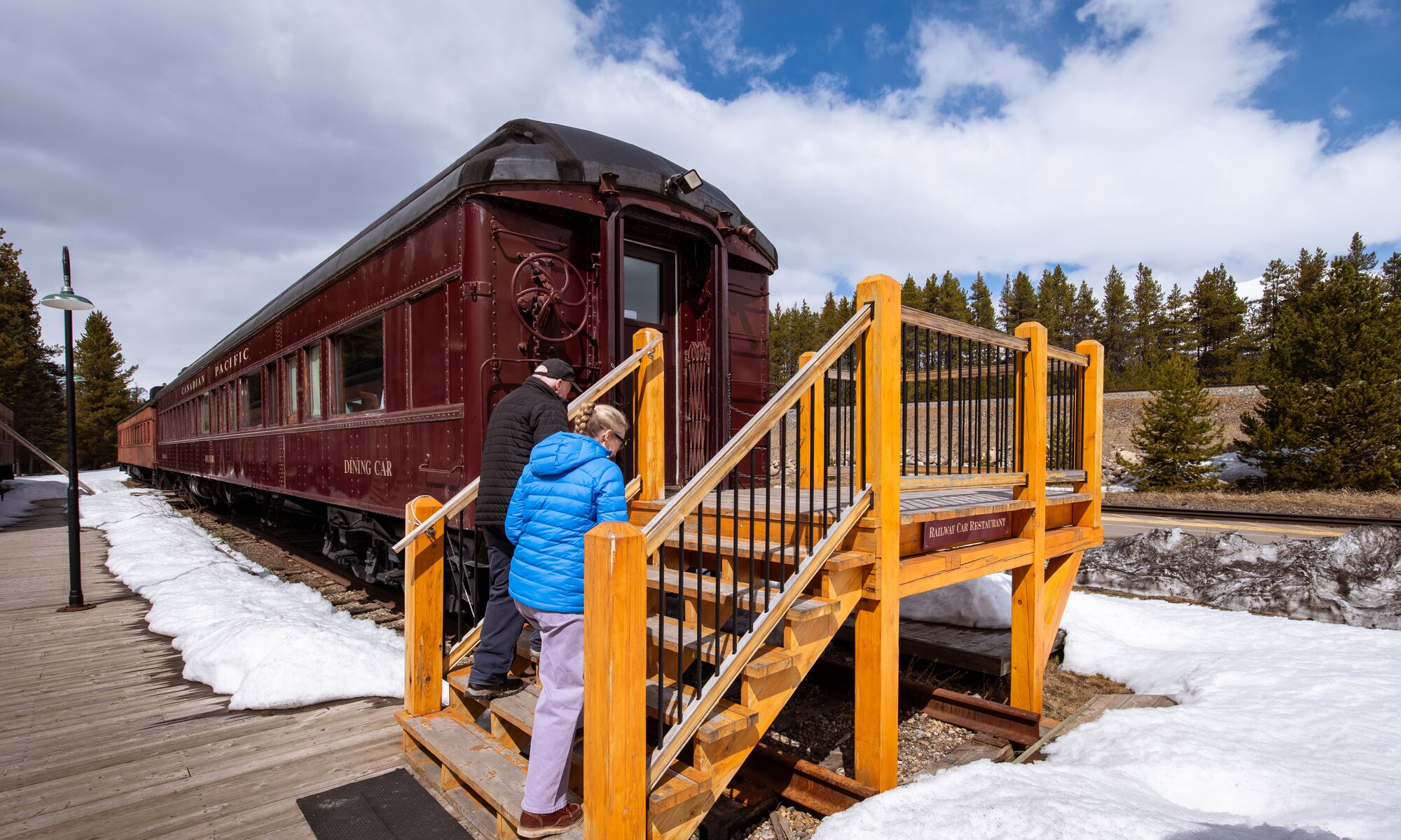 Travelers entering The Station Restaurant in Lake Louise Restored Delamere Dining Car for a private dinner